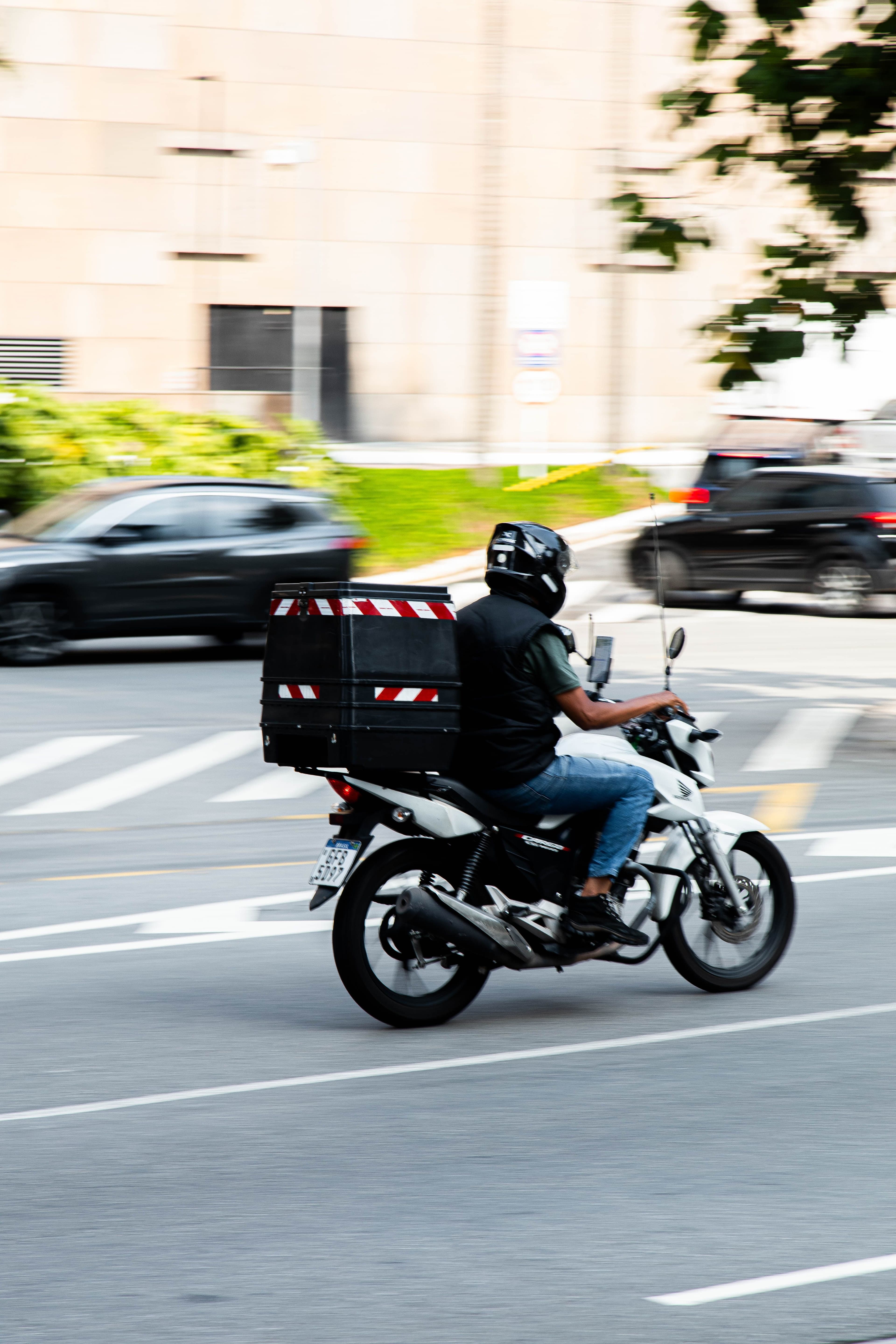Field agent on a motorbike with a delivery package