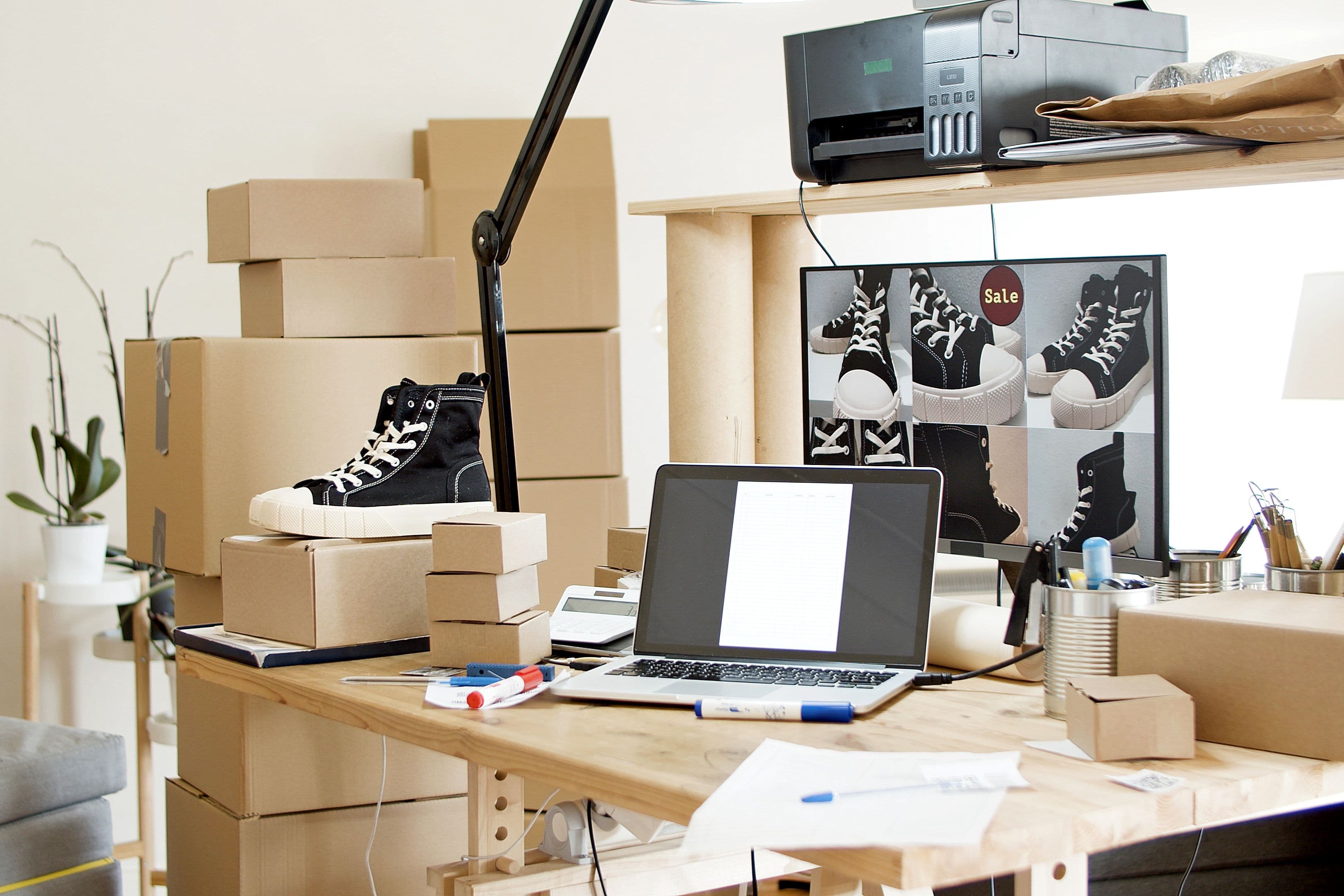 Analytics dashboard on a laptop beside boxes